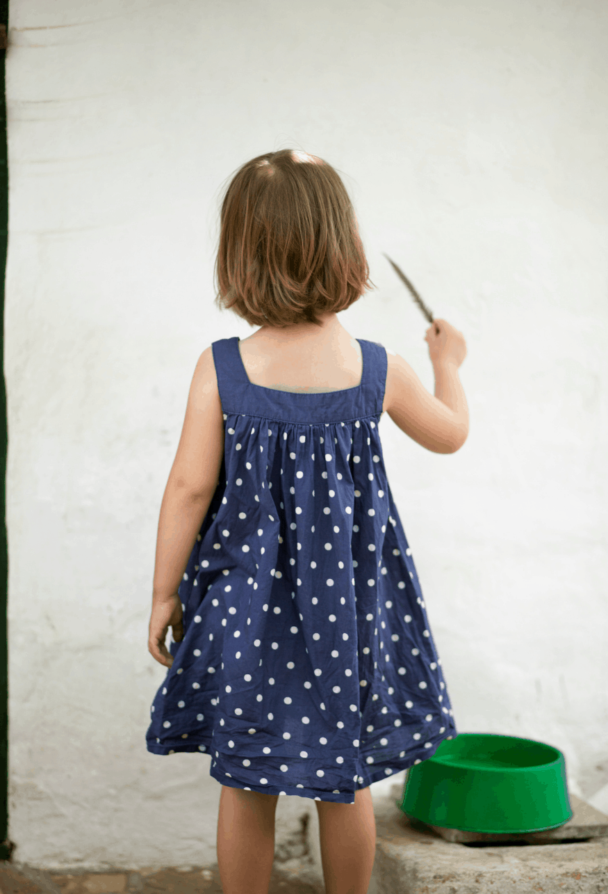 child drawing on wall